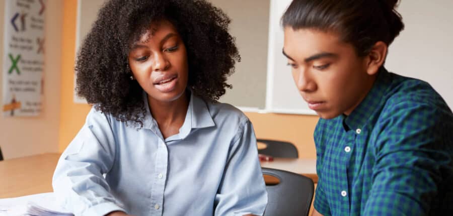 Tutor helping student study