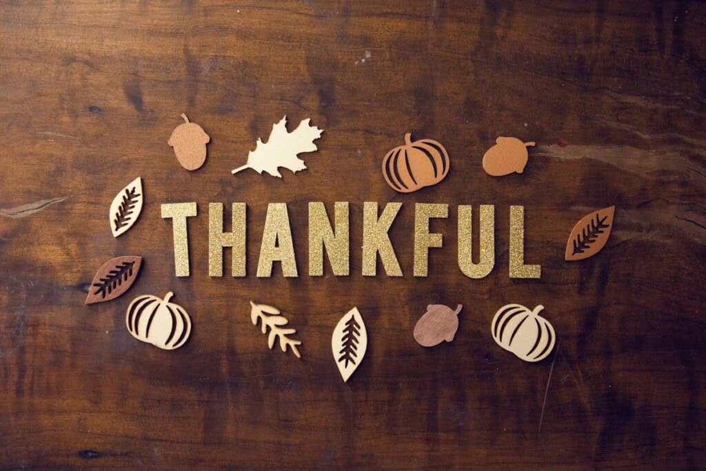 Overhead view of the word Thankful on a wood background