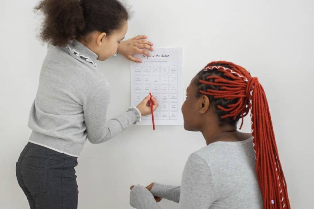 Black mother and daughter working on a organization list together